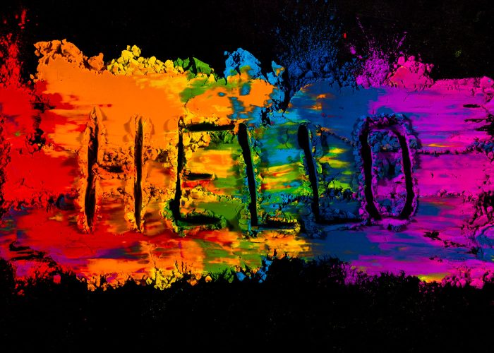 handwritten-hello-text-colorful-holi-powder-color-against-black-background